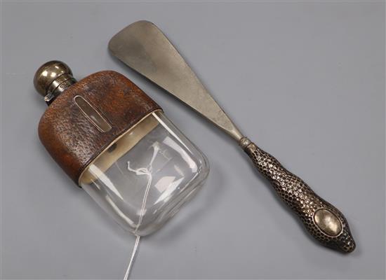 A silver mounted leather covered glass spirit flask and a silver handled shoe horn.